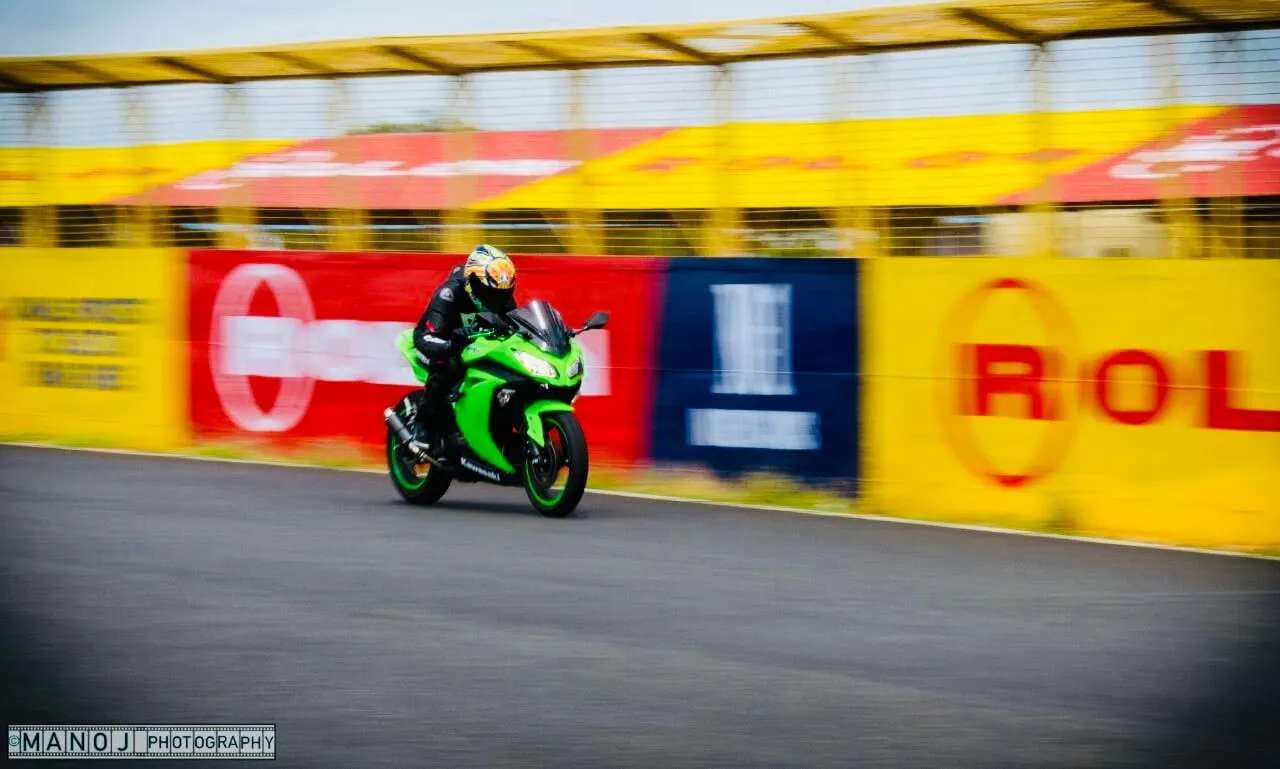 The Ninja on a panning shot down the straight past the trackside hoardings