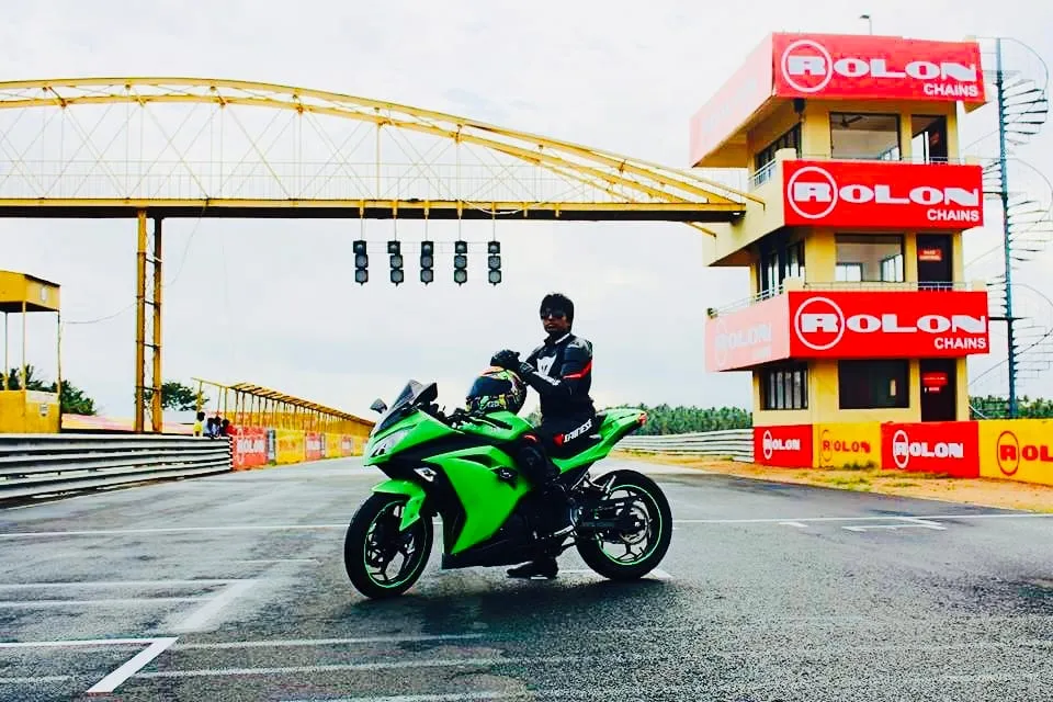 Sitting on the Ninja under the start gantry, beside the timing tower