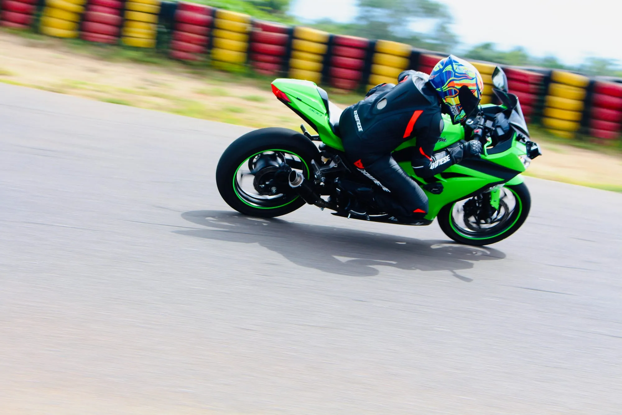 Knee down on the Ninja through a corner, tyre wall blurred behind